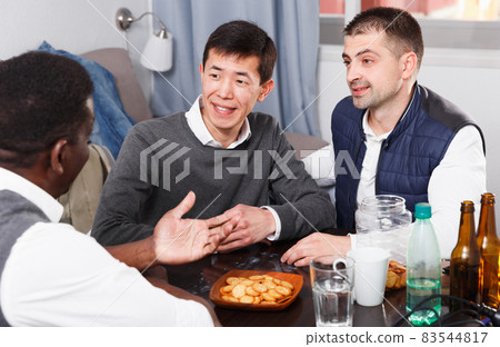 Friendly meeting in men company at home table 83544817
