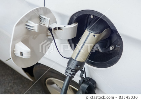 EV charging electric car ecology city vehicle plug. Electric car charger connector for charging electric vehicle socket parking EV charger car recharge battery power. Electric vehicle charging station 83545030