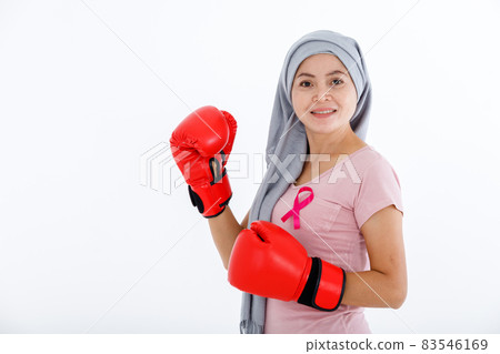 a asian woman fighting showing boxing gloves breast cancer awareness month isolated on white blank copy space studio background,healthcare,medicine concept 83546169