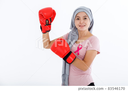 a asian woman fighting showing boxing gloves breast cancer awareness month isolated on white blank copy space studio background,healthcare,medicine concept 83546170