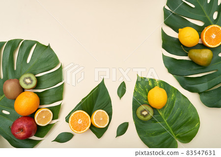 Directly above view of fresh ripe fruits on tropical leaves on isolated background Directly above view of fresh ripe fruits on tropical leaves on isolated background 83547631