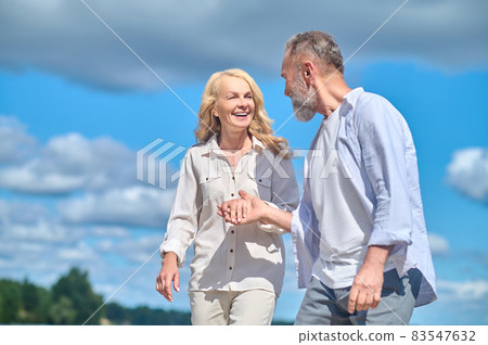 Happy cheerful man and woman walking in nature Happy cheerful man and woman walking in nature 83547632