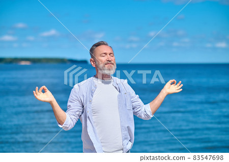 Man meditating in pose of gyana mudra Man meditating in pose of gyana mudra 83547698