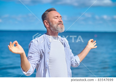 Man in gyana mudra pose in nature Man in gyana mudra pose in nature 83547699