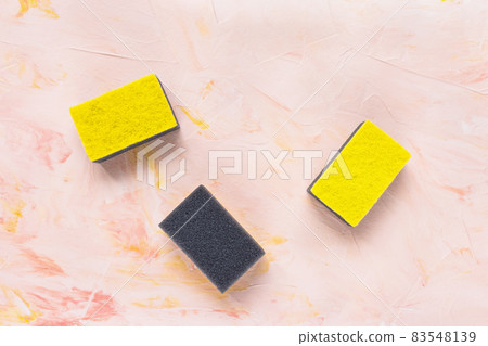 New yellow and gray sponges for dishwashing on pink background. Domestic household and cleaning concept. Close up, copy space 83548139
