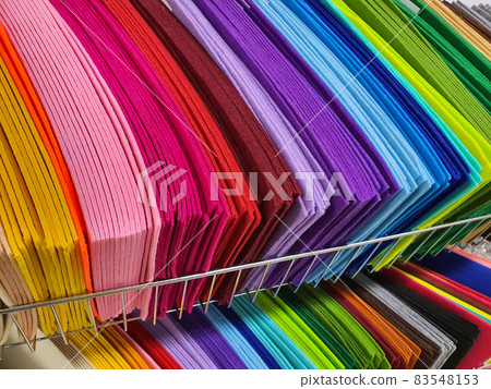 Pieces of colorful textile, samples of felt in different color for sewing on shelves in the hobby shop. Diy and handcraft concept 83548153