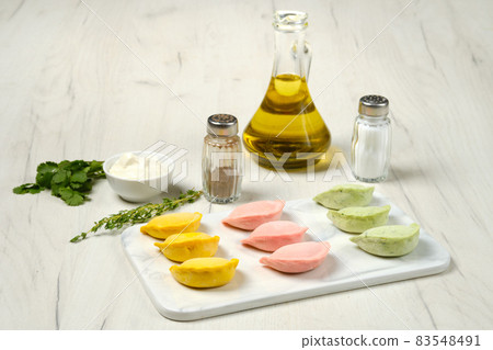 Frozen colorful pelmeni with chicken and turkey ground meat Frozen colorful pelmeni with chicken and turkey ground meat 83548491