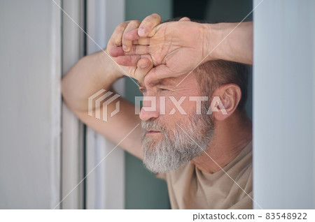 Serious pensive mature man looking at something 83548922