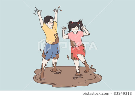 Happy small kids play jump in dirty puddle Happy small kids play jump in dirty puddle 83549318