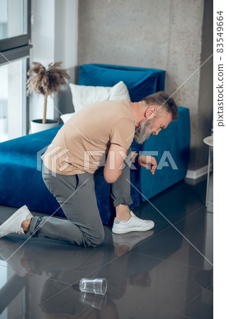 A mature bearded man having a heart attack and feeling bad A mature bearded man having a heart attack and feeling bad 83549664