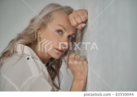 Cheerless woman staring in front of her 83550044