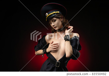 a young girl in a military police uniform for sexual games in leather handcuffs and a collar 83550492