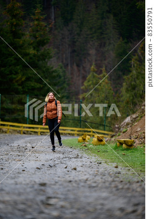 Tourist in the Carpathians, a girl on a background of mountains in the rehabilitation center of brown bears, Synevyr glade. Tourist in the Carpathians, a girl on a background of mountains in the rehabilitation center of brown bears, Synevyr glade. 83550791