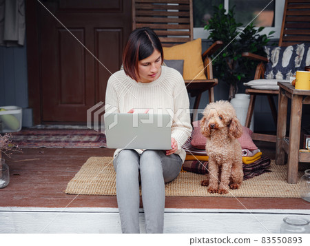 woman with laptop working outdoors in garden 83550893