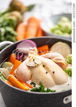 Chicken ready to cook broth with fresh root vegetables and spices Chicken ready to cook broth with fresh root vegetables and spices 83551589