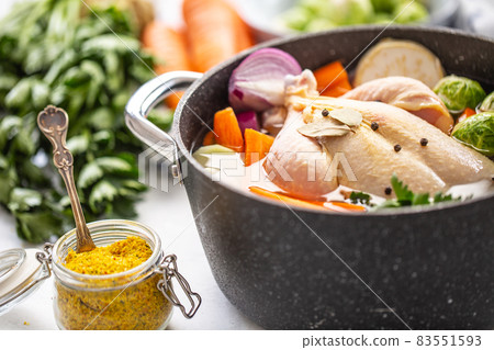 Chicken ready to cook broth with fresh root vegetables and spices Chicken ready to cook broth with fresh root vegetables and spices 83551593