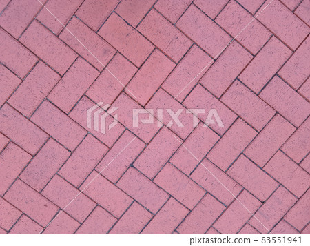 Paving slabs laid out in shape of herringbone on city street background 83551941