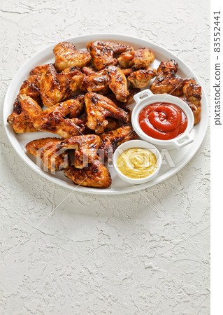 crispy fried chicken wings served on a plate crispy fried chicken wings served on a plate 83552441