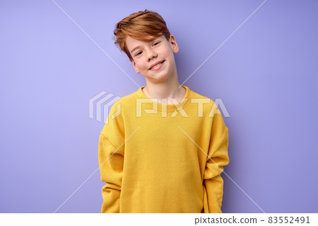 Shy Caucasian Teenage Boy Looking At Camera, Smiling, Isolated On Purple Shy Caucasian Teenage Boy Looking At Camera, Smiling, Isolated On Purple 83552491