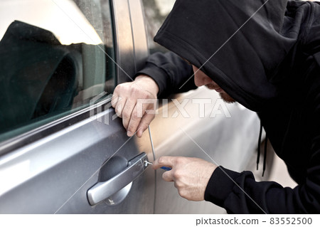 Car thief steal auto breaking door criminal job burglar Hijacks, young car thief outdoors 83552500