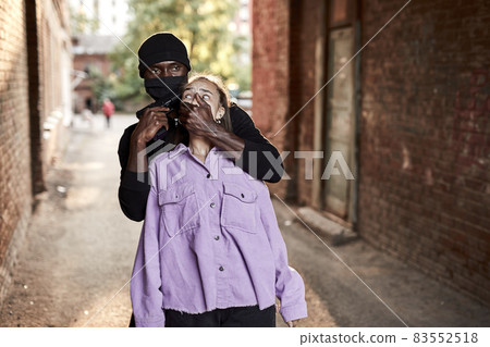 black african aggressive man hold young caucasian woman, violence sex crime 83552518