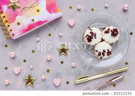 Notepad, pens, cookies on pink background with stars, hearts and pearls. Woman home office, lifestyle, To Do List concept. Flat lay, top view 83552535