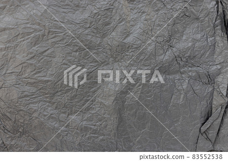 Crumpled black kraft paper for gift wrapping or packaging. Close up, texture background, polution and recycling concept Crumpled black kraft paper for gift wrapping or packaging. Close up, texture background, polution and recycling concept 83552538