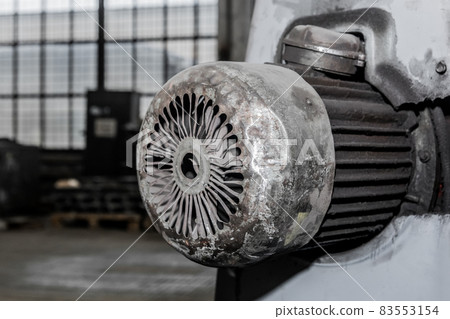 Old flange motor of milling machine industrial equipment in the factory workshop 83553154