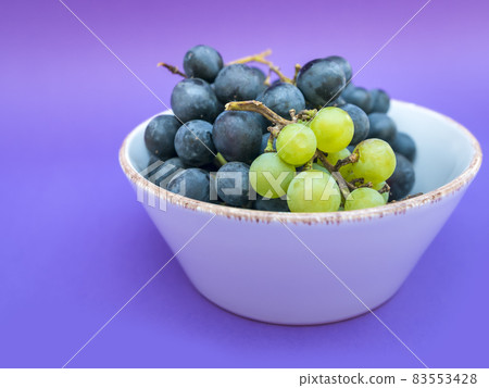 Red and white grapes, purple background. Top view, vintage,wine concept 83553428