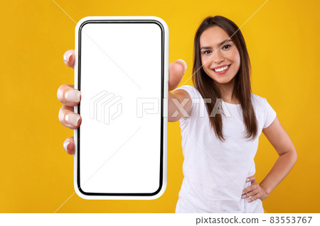 Woman showing white empty smartphone screen close up to camera 83553767