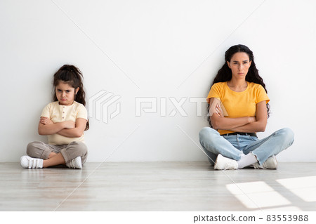 Grumpy Young Mother And Little Daughter Sitting Offended After Argue At Home Grumpy Young Mother And Little Daughter Sitting Offended After Argue At Home 83553988