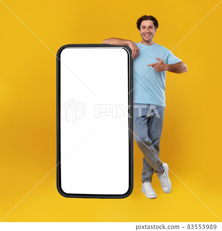 Man pointing at big white empty smartphone screen, mockup Man pointing at big white empty smartphone screen, mockup 83553989