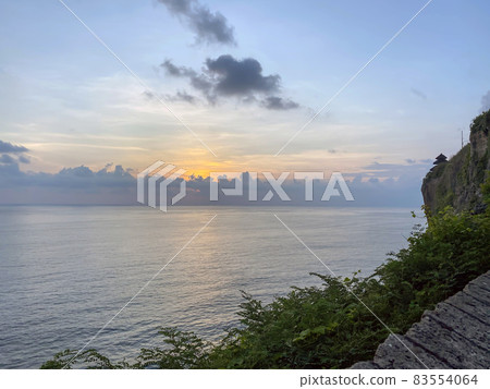 Sunset from the Pura Uluwatu temple on Bali island in Indonesia. - stock photo Sunset from the Pura Uluwatu temple on Bali island in Indonesia. - stock photo 83554064