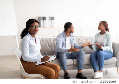 Female psychologist and young black couple having conflict during marital therapy at office, copy space Female psychologist and young black couple having conflict during marital therapy at office, copy space 83554066