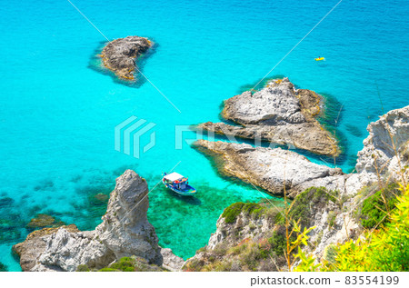 Fishing yacht and rubber boat in Capo Vaticano lagoon, Calabria, Italy Fishing yacht and rubber boat in Capo Vaticano lagoon, Calabria, Italy 83554199