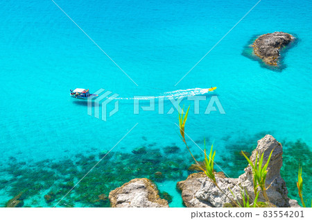 Fishing yacht and rubber boat in Capo Vaticano lagoon, Calabria, Italy Fishing yacht and rubber boat in Capo Vaticano lagoon, Calabria, Italy 83554201