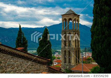 Bell tower in front of mountains in town Kalabaka, Greece Bell tower in front of mountains in town Kalabaka, Greece 83554230