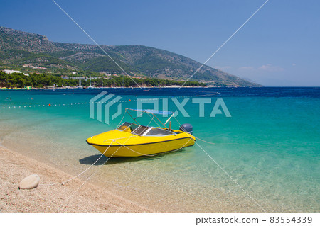 Yellow boat near cape Zlatni Rat of Brac Island, Adriatic Sea, Croatia 83554339