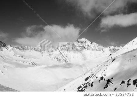Black and white off-piste slope and chair-lift on ski resort at sun day 83554758