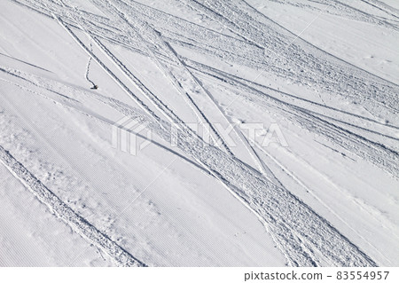 Groomed snowy ski slope with trace from skis and snowboards at winter 83554957
