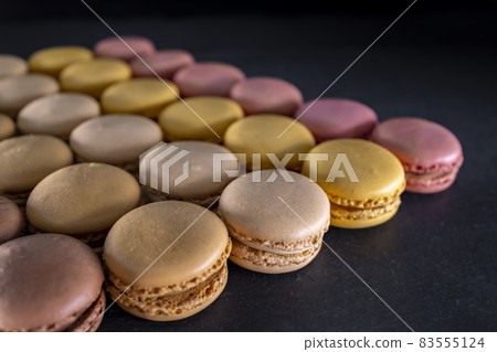 chocolate, coffee, vanilla, lemon and strawberry macaroons on black background chocolate, coffee, vanilla, lemon and strawberry macaroons on black background 83555124