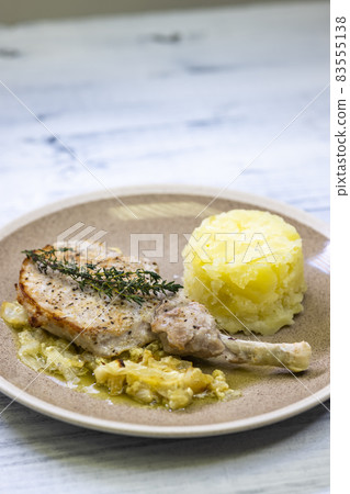 pork chop with thyme baked on creamy onion with mashed potatoes 83555138