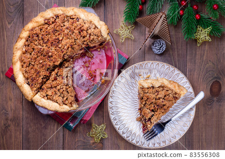 Freshly baked American apple cranberry pie, in baking dish and on plate Freshly baked American apple cranberry pie, in baking dish and on plate 83556308