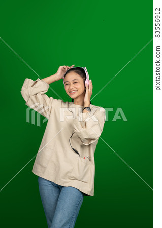 excited young girl wearing headphones listening to music excited young girl wearing headphones listening to music 83556912
