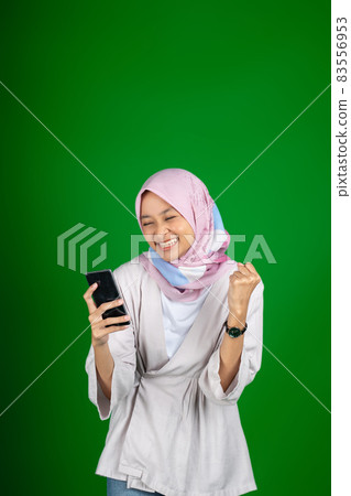asian girl excitedly when looking at mobile phone screen asian girl excitedly when looking at mobile phone screen 83556953