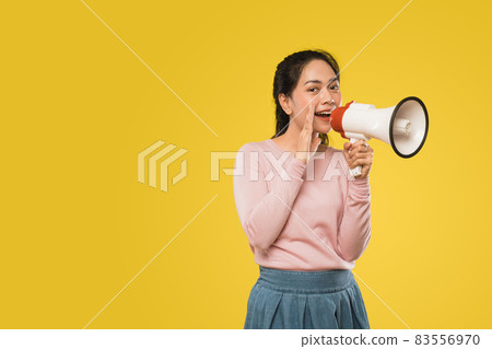 girl with hands beside mouth making announcement using megaphone girl with hands beside mouth making announcement using megaphone 83556970