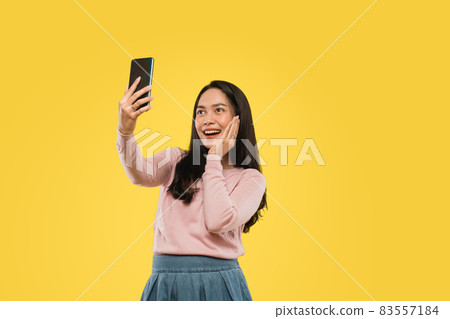 beautiful woman hand on cheek while selfie with camera smartphone 83557184
