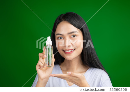 beautiful woman holding serum spray bottle on green screen beautiful woman holding serum spray bottle on green screen 83560206