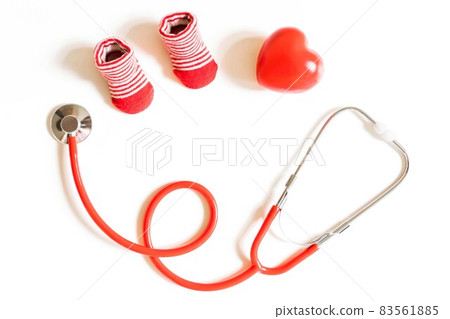 baby shoes, small heart and stethoscope on white background. Concept of visiting children's doctor baby shoes, small heart and stethoscope on white background. Concept of visiting children's doctor 83561885