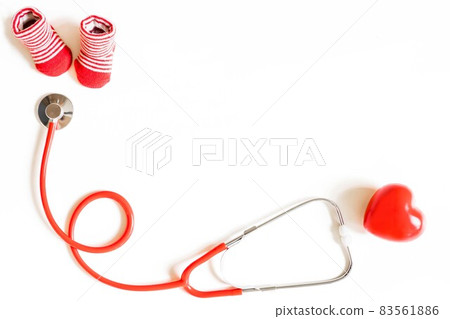 baby shoes, small heart and stethoscope on white background. Concept of visiting children's doctor, copy space baby shoes, small heart and stethoscope on white background. Concept of visiting children's doctor, copy space 83561886